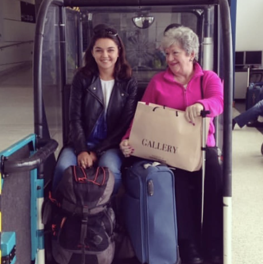 Elderly traveler being assisted at airport